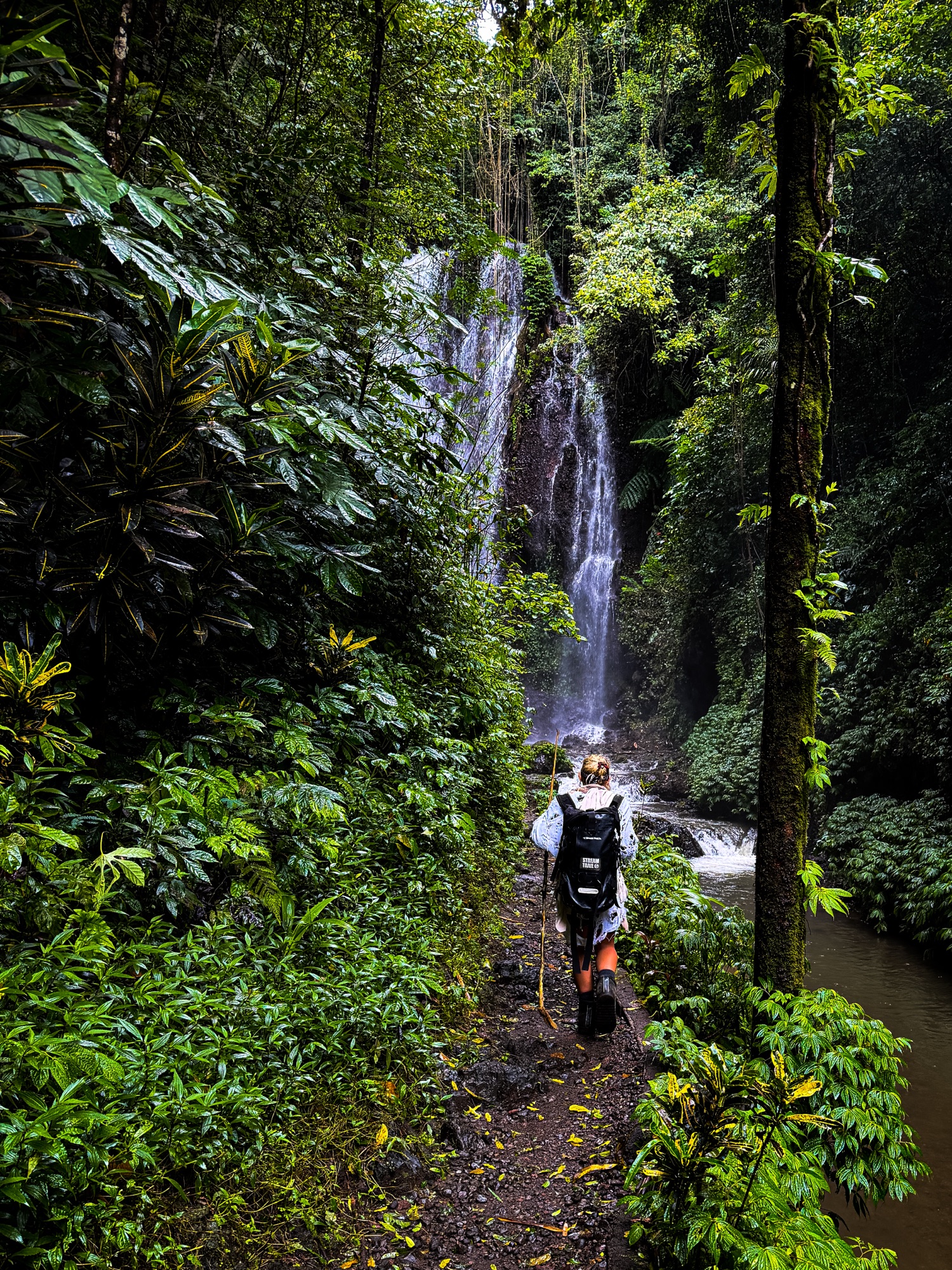 ZØ hiking the jungle trail to the waterfall in Bali, where CRÜZØR started